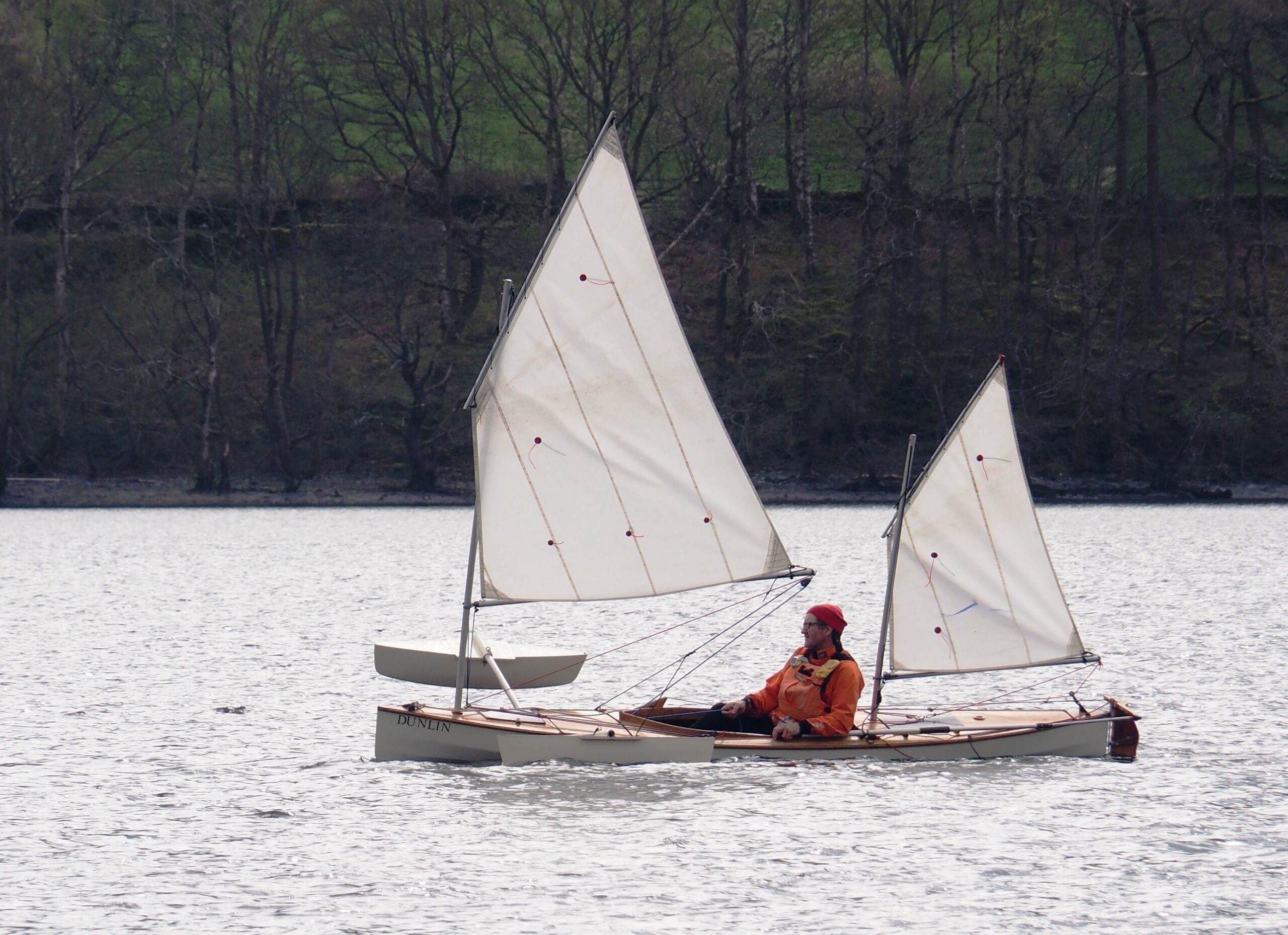 A canoe rigged with two lugsails on Coniston Water