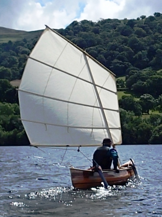 wooden sailing canoe